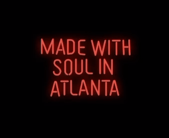 A flickering neon of a Made with soul in atlanta sign